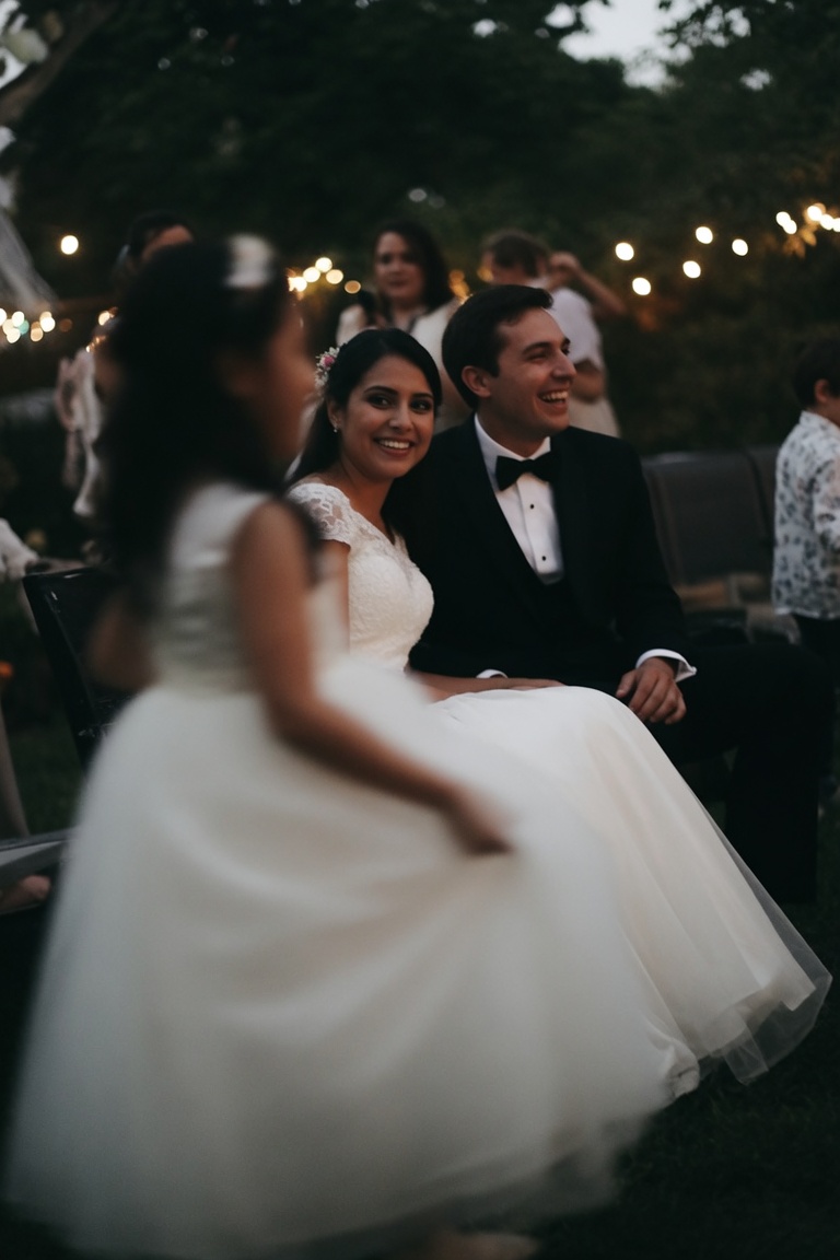 Bride and groom laughing together outdoors